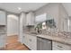 Well-lit kitchen with stainless steel appliances, stone countertops, and a mosaic tile backsplash at 1861 E Glancy Dr, Deltona, FL 32725