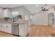 Well-appointed kitchen with stone countertops, stainless steel appliances, and modern ceiling fan at 1861 E Glancy Dr, Deltona, FL 32725