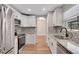 Bright kitchen featuring stainless steel appliances, stone countertops, new cabinets, and stylish backsplash at 1861 E Glancy Dr, Deltona, FL 32725