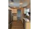 Renovated kitchen featuring stainless steel appliances, stone countertops, and stylish mosaic backsplash at 1861 E Glancy Dr, Deltona, FL 32725