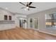 Spacious living room with wood floors, ceiling fan, and view of the modern kitchen at 1861 E Glancy Dr, Deltona, FL 32725