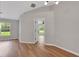 Spacious living room featuring wood-look flooring, natural light, and neutral paint at 1861 E Glancy Dr, Deltona, FL 32725