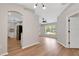 Open-concept living room featuring wood floors, natural light, and views into the kitchen at 1861 E Glancy Dr, Deltona, FL 32725