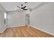 Neutral living room with wood floors, ceiling fan, and view of hallway at 1861 E Glancy Dr, Deltona, FL 32725