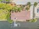 Aerial view of the waterfront property featuring a dock, spacious yard, and lush landscaping at 2384 John Anderson Dr, Ormond Beach, FL 32176
