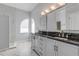 Bathroom featuring double vanity with granite countertop and a glass enclosed shower at 2384 John Anderson Dr, Ormond Beach, FL 32176