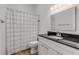 Bathroom featuring a vanity with a black countertop and wood-look floors at 2384 John Anderson Dr, Ormond Beach, FL 32176