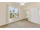 Bedroom featuring carpet flooring, a ceiling fan, a mirrored closet, and a large window with a view at 2384 John Anderson Dr, Ormond Beach, FL 32176