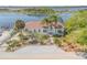 Charming waterfront home with lush landscaping, palm trees, and a private dock on a tranquil bay at 2384 John Anderson Dr, Ormond Beach, FL 32176