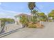Two-story waterfront home with a long driveway, attached garage and lush landscaping, providing privacy and curb appeal at 2384 John Anderson Dr, Ormond Beach, FL 32176