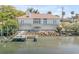 Waterfront home with outdoor kitchen, patio, wooden dock providing direct access to the water at 2384 John Anderson Dr, Ormond Beach, FL 32176