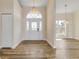 Welcoming foyer featuring hardwood floors, decorative lighting, and a charming front door with sidelights at 2384 John Anderson Dr, Ormond Beach, FL 32176