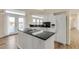 Modern kitchen island with black countertops, white cabinets and water views at 2384 John Anderson Dr, Ormond Beach, FL 32176