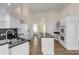 Well-lit kitchen featuring white cabinets, black countertops, and stainless steel appliances at 2384 John Anderson Dr, Ormond Beach, FL 32176