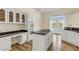 Bright kitchen with center island, white cabinets, and views of the water at 2384 John Anderson Dr, Ormond Beach, FL 32176