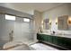 Spa-like bathroom featuring double sinks, marble floors, a bathtub, and a glass enclosed shower at 2422 Musselwhite Ave, Orlando, FL 32804
