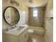 Updated bathroom with quartz countertop, round mirror, and tiled shower/tub combo at 2514 Highlawn Ave, Sanford, FL 32773