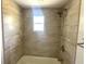 Bathtub in tiled shower with a window at 2514 Highlawn Ave, Sanford, FL 32773