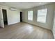 Comfortable bedroom with hardwood floors, AC unit, and three windows for plenty of natural light at 2514 Highlawn Ave, Sanford, FL 32773