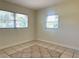 Bedroom with unique tile floors and two windows letting in natural light at 2514 Highlawn Ave, Sanford, FL 32773