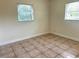 Bedroom with tile floors, white walls, and two windows letting in natural light at 2514 Highlawn Ave, Sanford, FL 32773