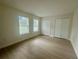 Bright bedroom featuring fresh paint, modern floors, and two large closets at 2514 Highlawn Ave, Sanford, FL 32773