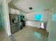 Modern kitchen with stainless steel appliances and sleek, white cabinets at 2514 Highlawn Ave, Sanford, FL 32773