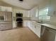 Modern kitchen with stainless steel appliances, stylish white cabinets, and quartz countertops at 2514 Highlawn Ave, Sanford, FL 32773