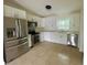 Modern kitchen with stainless steel appliances, stylish white cabinets, and quartz countertops at 2514 Highlawn Ave, Sanford, FL 32773