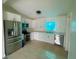 Modern kitchen with stainless steel appliances and sleek, white cabinets at 2514 Highlawn Ave, Sanford, FL 32773