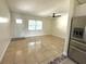 Inviting living room with tile floors, natural light, and easy access to the kitchen with stainless steel fridge at 2514 Highlawn Ave, Sanford, FL 32773