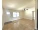 Open living room featuring tile floors, ceiling fan, and plenty of natural light from the window at 2514 Highlawn Ave, Sanford, FL 32773