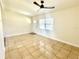 An open concept living room featuring tile floors and a ceiling fan at 2514 Highlawn Ave, Sanford, FL 32773