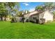 Lovely home featuring a spacious backyard with lush green lawn and mature landscaping at 262 W Sabal Palm Pl, Longwood, FL 32779