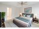 Bedroom with neutral walls, king bed, ceiling fan, and an ensuite bathroom at 262 W Sabal Palm Pl, Longwood, FL 32779