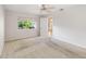 Neutral bedroom featuring a ceiling fan and a window with views of outdoor foliage at 262 W Sabal Palm Pl, Longwood, FL 32779