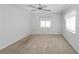 Spacious bedroom with neutral carpet, ceiling fan, and windows for ample natural lighting at 262 W Sabal Palm Pl, Longwood, FL 32779