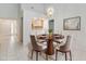 Cozy dining room with modern chandelier and seating for four at 262 W Sabal Palm Pl, Longwood, FL 32779