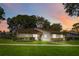 Charming single-story home featuring mature trees and a well-manicured lawn at 262 W Sabal Palm Pl, Longwood, FL 32779