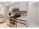 Galley kitchen featuring lots of bright cabinets and stainless steel appliances at 262 W Sabal Palm Pl, Longwood, FL 32779