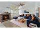 Bright living room with fireplace, large windows and a comfortable blue sectional couch at 262 W Sabal Palm Pl, Longwood, FL 32779