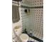 Bathroom with tiled shower, patterned tiles, and toilet at 300 Broadview Ave, Altamonte Springs, FL 32701