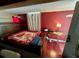 View of the bedroom with red walls and wood flooring at 300 Broadview Ave, Altamonte Springs, FL 32701