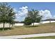 An open backyard with a white fence is perfect for outdoor activities and gatherings at 35734 Rose Moss Ave, Leesburg, FL 34788
