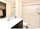 Clean bathroom featuring a large shower, white vanity, and well-lit mirror at 35734 Rose Moss Ave, Leesburg, FL 34788