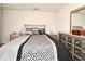 Bedroom featuring a modern bed with decorative pillows, matching nightstands, and a dresser with mirror at 35734 Rose Moss Ave, Leesburg, FL 34788