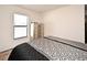 Bedroom with a decorative comforter, large windows with blinds, and silver nightstand and drawers at 35734 Rose Moss Ave, Leesburg, FL 34788