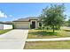 Attractive one-story home with a well-manicured front lawn, offering great curb appeal at 35734 Rose Moss Ave, Leesburg, FL 34788