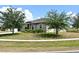 Well-kept one-story home with lush lawn and mature trees, perfect for enjoying the outdoors at 35734 Rose Moss Ave, Leesburg, FL 34788