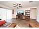Large living room with laminate flooring, media center and comfortable seating near sliding glass doors at 35734 Rose Moss Ave, Leesburg, FL 34788